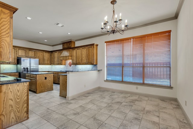 kitchen with decorative backsplash, stainless steel refrigerator with ice dispenser, decorative light fixtures, and a notable chandelier