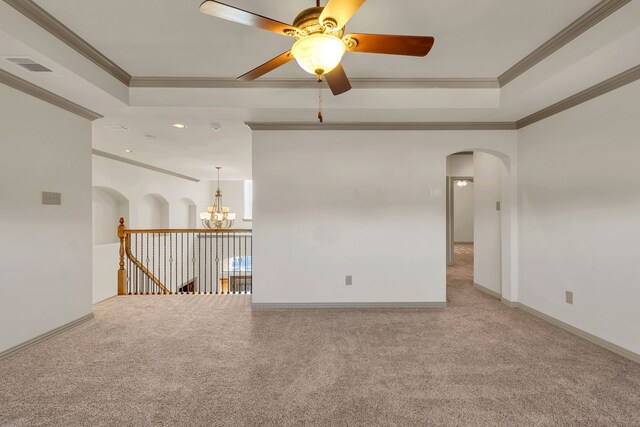 empty room featuring ceiling fan, light colored carpet, and ornamental molding