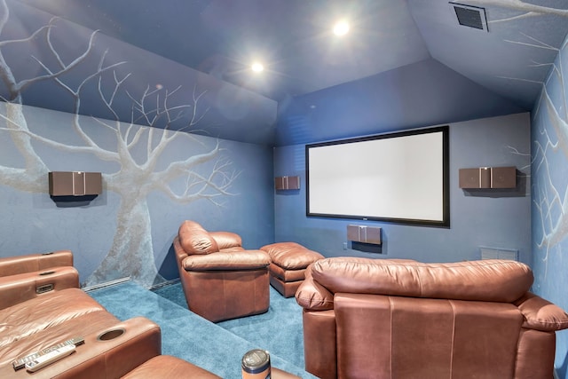 carpeted cinema featuring visible vents and vaulted ceiling