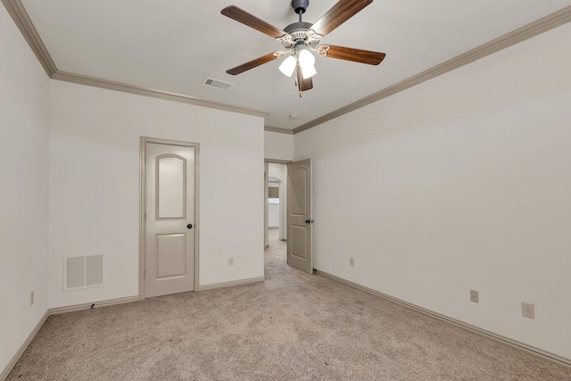 unfurnished bedroom featuring light colored carpet, ceiling fan, and crown molding