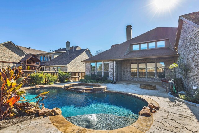 view of swimming pool with a patio area and an in ground hot tub