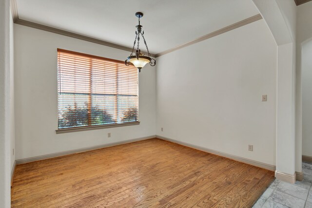 spare room with light hardwood / wood-style flooring and ornamental molding