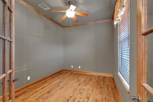 unfurnished living room featuring sink, wood-type flooring, ceiling fan with notable chandelier, and ornamental molding