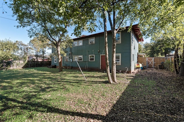 rear view of property with a lawn