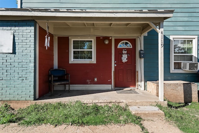 entrance to property featuring cooling unit