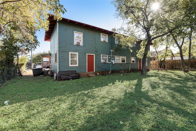 rear view of house with a lawn