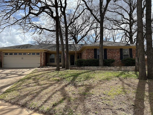 single story home with a garage, brick siding, and driveway