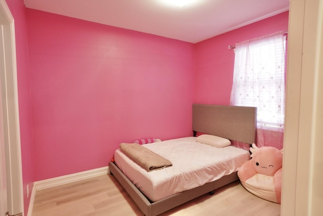 bedroom featuring hardwood / wood-style flooring and multiple windows