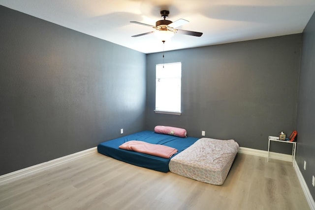 bedroom featuring ceiling fan and wood-type flooring