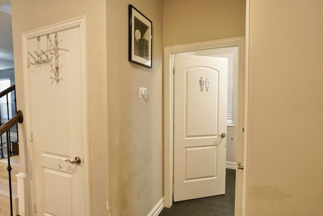 corridor with dark hardwood / wood-style flooring