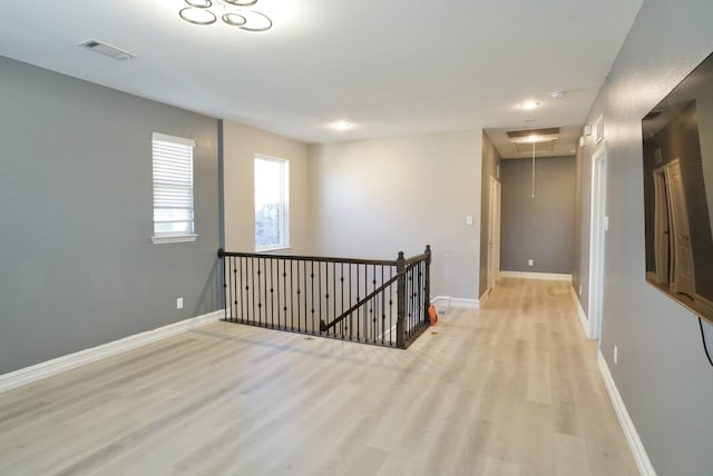 unfurnished room with light hardwood / wood-style floors