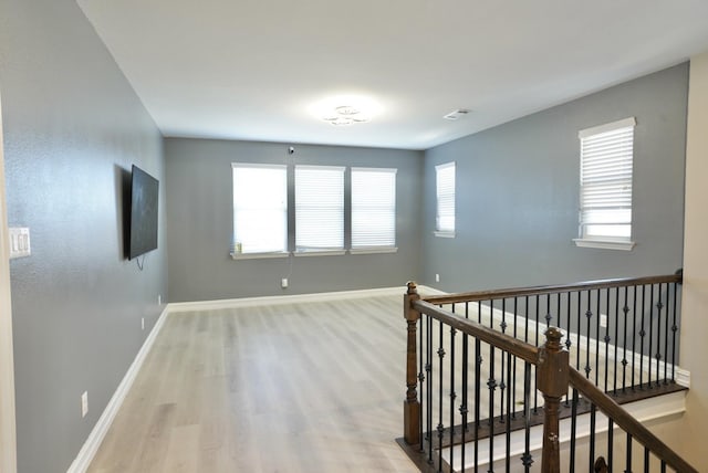 empty room with light hardwood / wood-style flooring