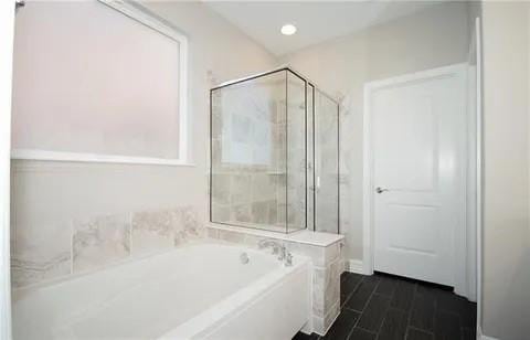 bathroom featuring independent shower and bath and hardwood / wood-style floors