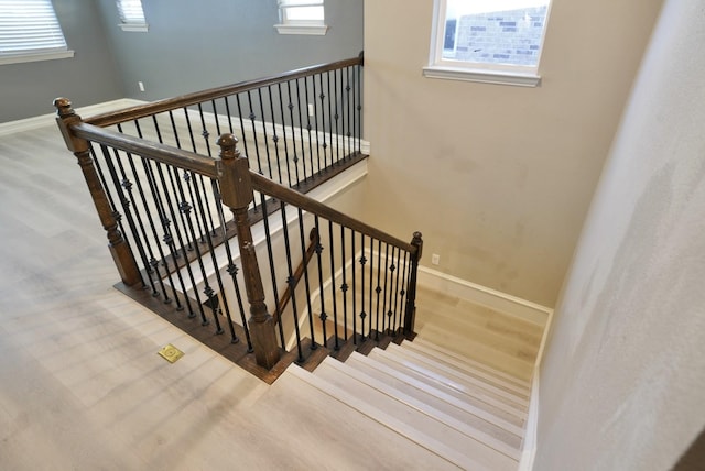 staircase featuring wood-type flooring