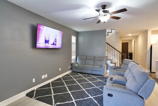 living room featuring dark hardwood / wood-style floors and ceiling fan