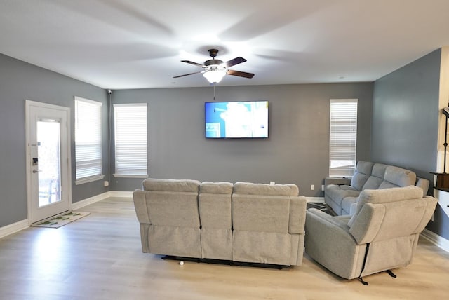 living room featuring ceiling fan and light hardwood / wood-style flooring