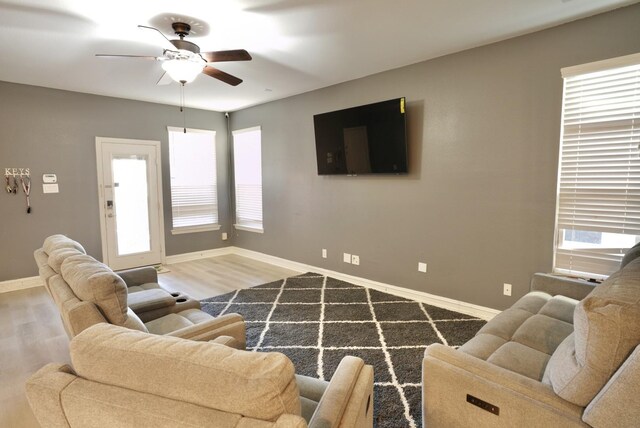 living room with hardwood / wood-style flooring and ceiling fan