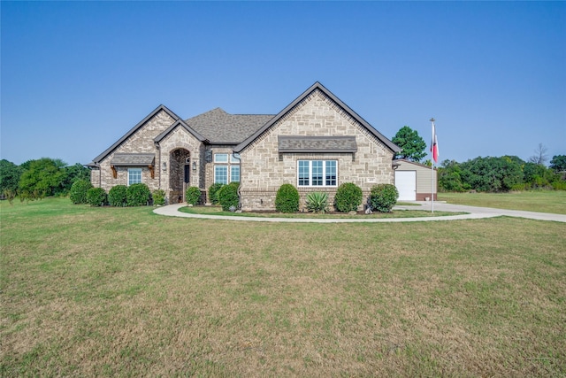 view of front facade with a front yard and a garage