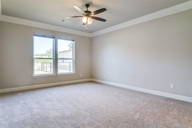 carpeted spare room with ornamental molding and ceiling fan