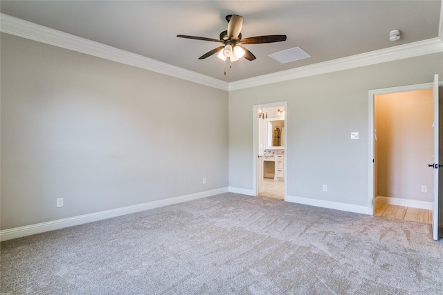 unfurnished bedroom featuring light carpet, connected bathroom, and ornamental molding