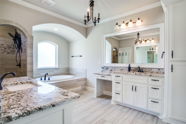 bathroom featuring ornamental molding, tiled bath, and vanity