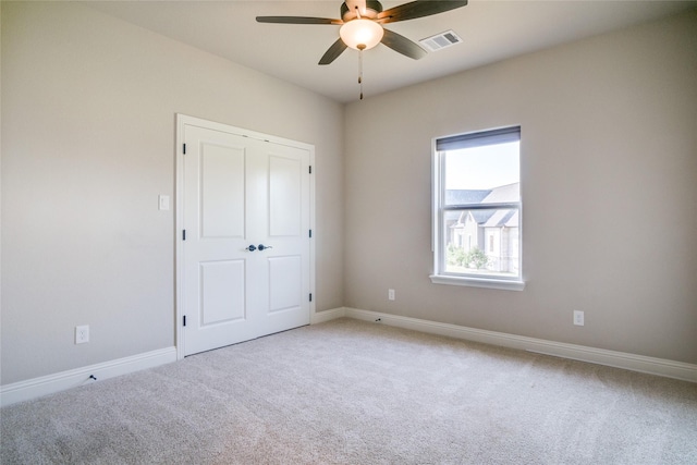 unfurnished bedroom with ceiling fan and carpet