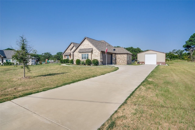 french provincial home with an outbuilding, a garage, and a front lawn