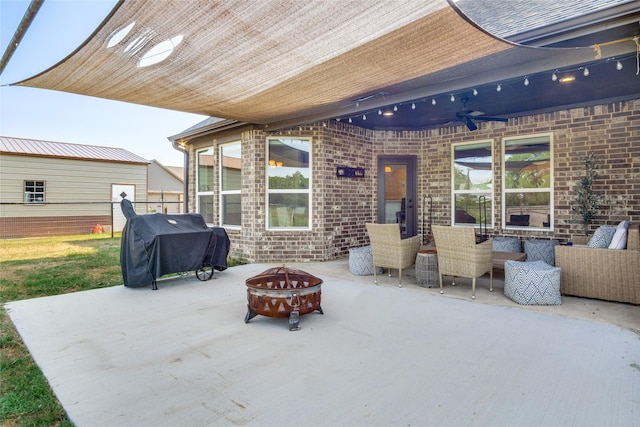 view of patio with a grill, ceiling fan, and an outdoor fire pit