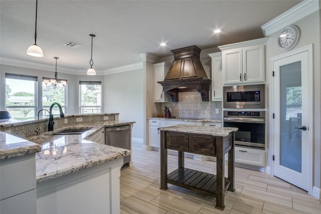 kitchen featuring appliances with stainless steel finishes, decorative light fixtures, custom exhaust hood, and white cabinets