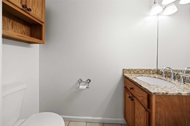 bathroom with tile patterned floors, vanity, and toilet