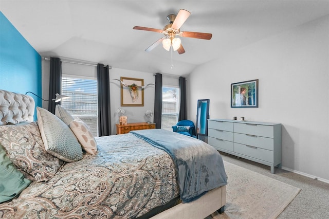 bedroom featuring ceiling fan, vaulted ceiling, and light carpet