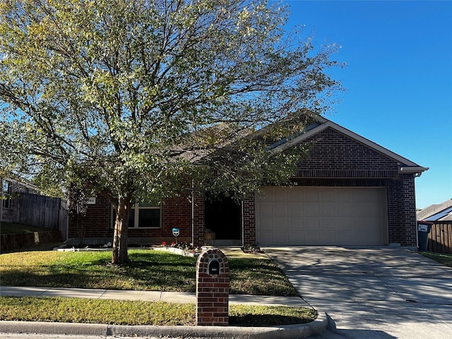 view of front of home featuring a garage and a front yard