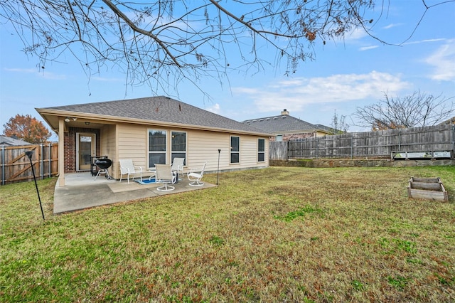 rear view of house featuring a patio and a lawn