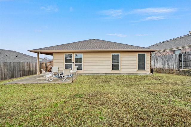 back of house with a patio area and a lawn