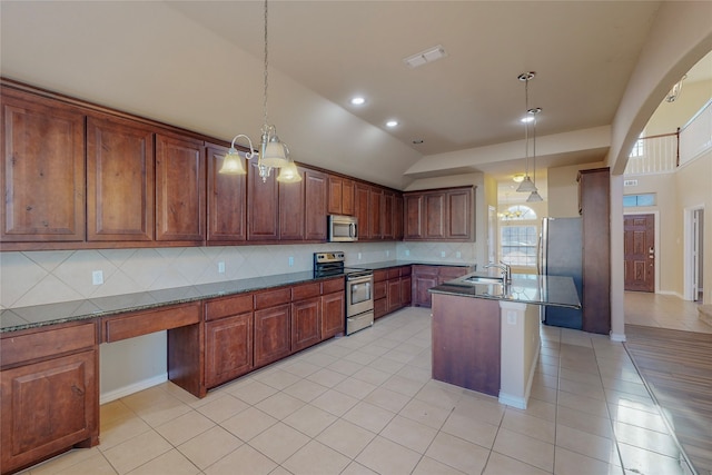 kitchen featuring pendant lighting, decorative backsplash, light tile patterned floors, and appliances with stainless steel finishes