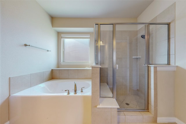 bathroom with separate shower and tub