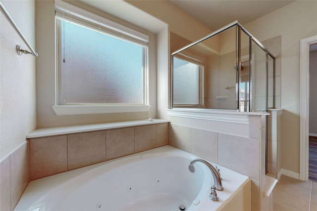 bathroom featuring shower with separate bathtub