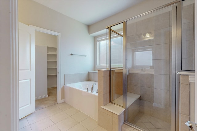 bathroom with separate shower and tub and tile patterned floors