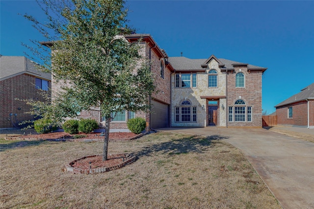 view of front of property featuring a front lawn and a garage