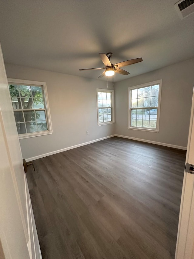 unfurnished room with ceiling fan and dark wood-type flooring