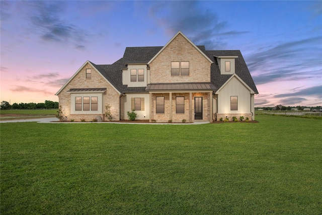 view of front facade featuring a lawn and a porch