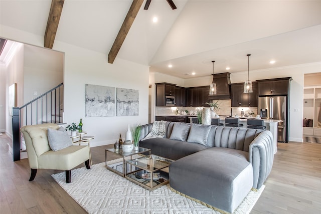 living room with ceiling fan, beam ceiling, light hardwood / wood-style floors, and high vaulted ceiling