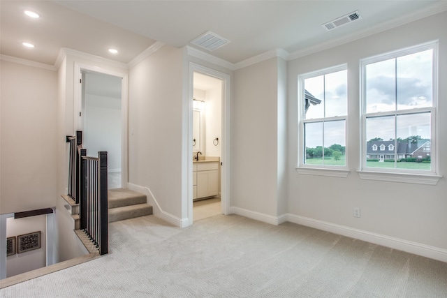 corridor with light carpet and crown molding