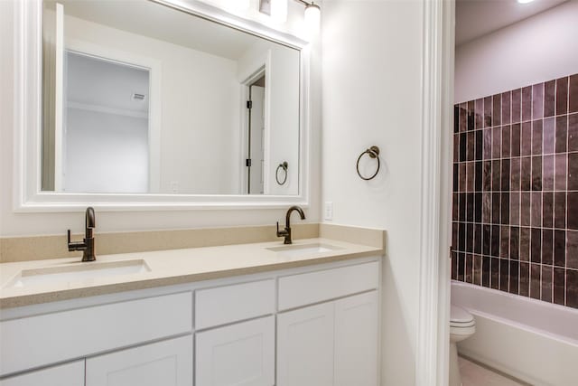 full bathroom with vanity, toilet, and tiled shower / bath