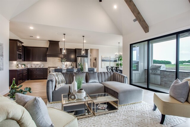 living room featuring beam ceiling, light hardwood / wood-style flooring, high vaulted ceiling, and a notable chandelier