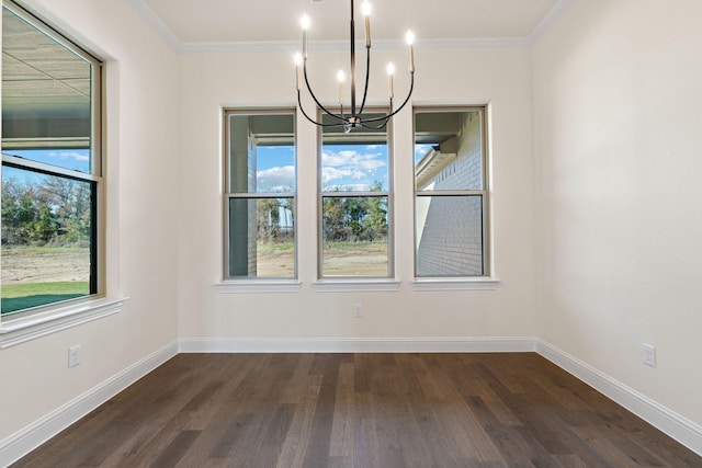 unfurnished dining area with a notable chandelier, a healthy amount of sunlight, ornamental molding, and dark wood-type flooring