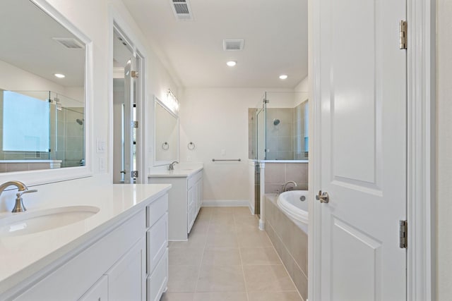 bathroom featuring tile patterned flooring, vanity, and shower with separate bathtub
