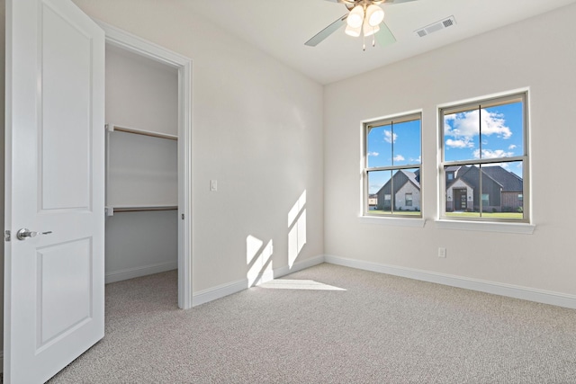 unfurnished bedroom featuring ceiling fan, a closet, and light carpet