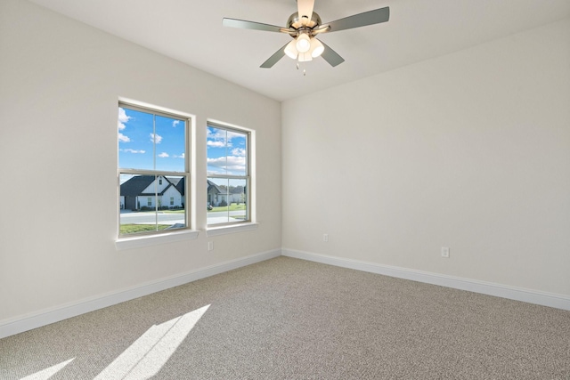 spare room featuring carpet flooring and ceiling fan