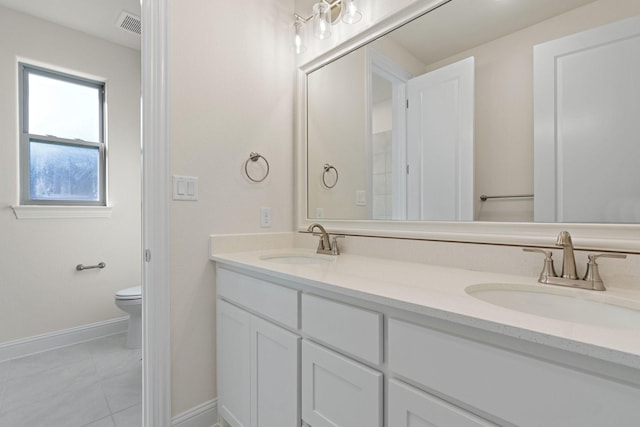 bathroom featuring tile patterned floors, vanity, and toilet